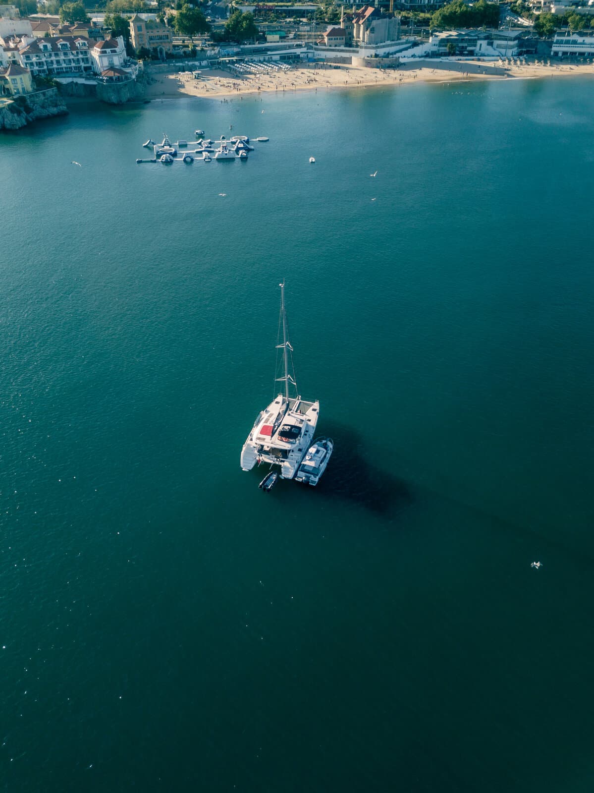 Catamaran at anchor by the marina