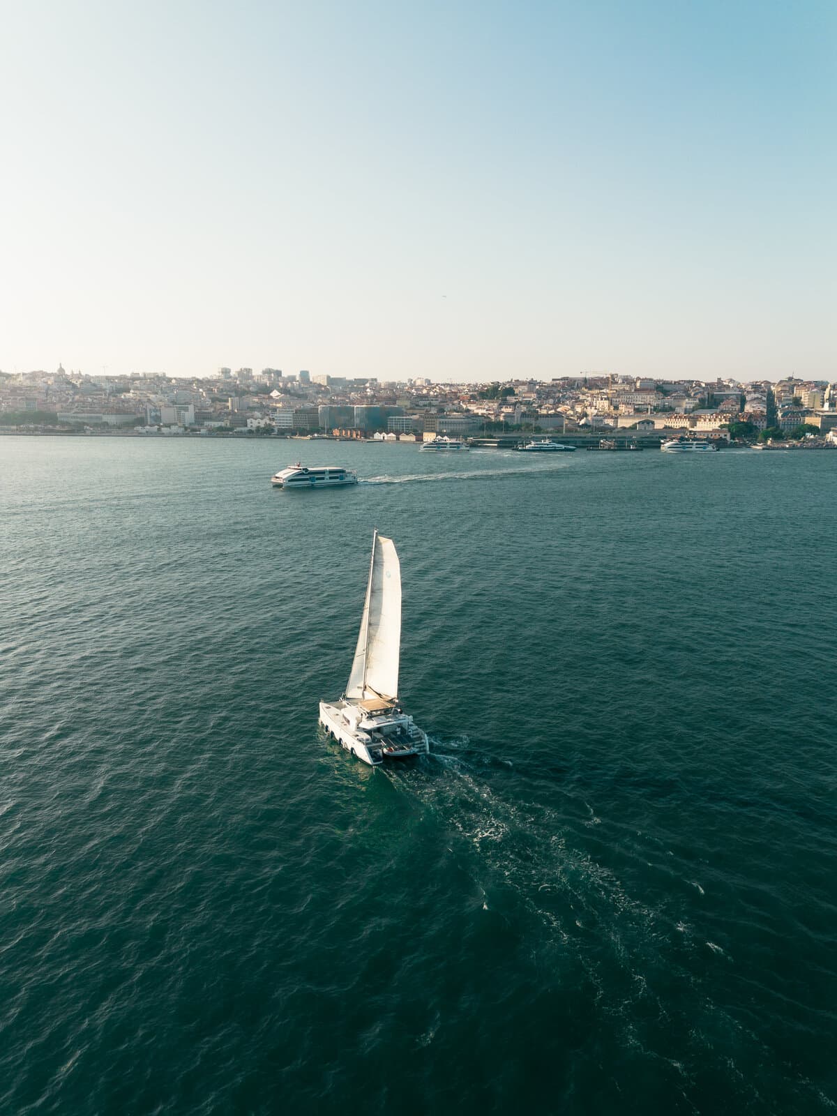 Catamaran under sail off the city